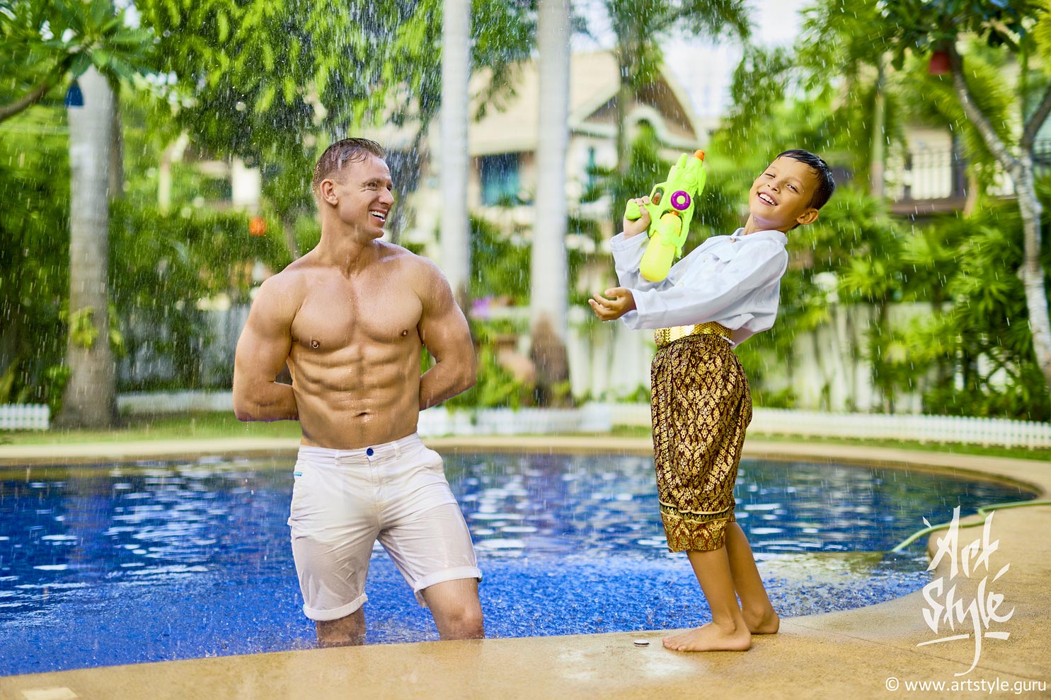 Father and his son are playing at Songkran